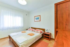 a bedroom with a large bed and a window at Apartment house Inga in Vir +111 photos