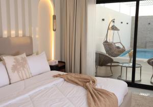 a bedroom with a bed and a swing in a room at Quiet House villa in Hatta