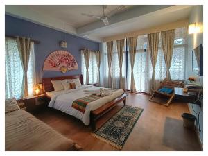 a bedroom with a large bed and some windows at Sha Ri Loum Homestay in Shillong