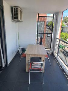 a balcony with a table and chairs on a balcony at Cap Au Soleil in Saint-Pierre