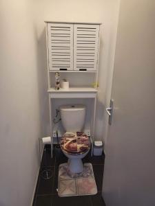 a bathroom with a toilet with a lid on the floor at Cap Au Soleil in Saint-Pierre