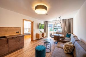 uma sala de estar com um sofá e uma mesa em Rustika - Appartements & Spa em Ehrwald