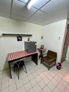 a kitchen with a table and a bench in a room at Ratanawong Place 553 in Bangkok