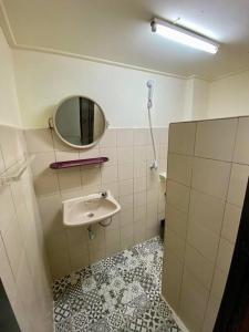 a bathroom with a sink and a mirror at Ratanawong Place 553 in Bangkok +12 photos