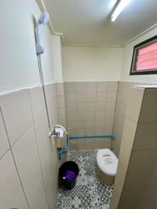 a small bathroom with a toilet and a sink at Ratanawong Place 553 in Bangkok