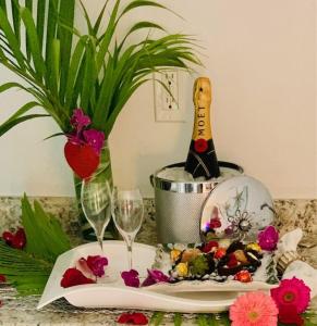 a table with a bottle of champagne and wine glasses at In the Heart of Naples, Suite with Lake & Pool in Naples