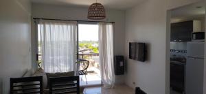 a kitchen with a large sliding glass door to a balcony at Salvia in Trenque Lauquen