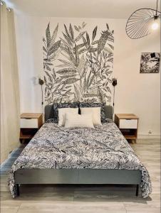 um quarto com uma cama com uma grande parede de plantas em Appartement studio avec terrasse et jardin privés em Boulogne-sur-Mer