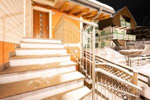 a set of stairs outside of a house in the snow at Cesa Antermoia in Mazzin