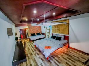 a bedroom with two beds and a brick wall at Yi family Homestay in Siem Reap