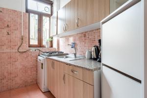 a small kitchen with a sink and a stove at Chic Taksim Flat 1 min to Istiklal Ave in Istanbul