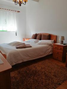 a bedroom with a large bed and a dresser at Sea and Beach Apartamento in Vieira de Leiria