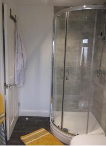 a shower in a bathroom with a glass shower stall at York City Homestays in York