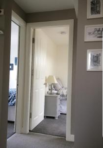 a hallway with a room with a bed and a lamp at York City Homestays in York