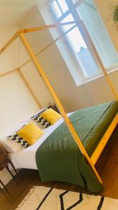 a bed in a room with a window at Maison de l'enfant gites 