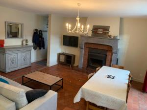 a living room with a couch and a fireplace at Charmant appartement jardin/parking privé 4 personnes in La Bourboule