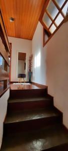 um quarto com escadas e uma televisão e uma janela em Apartamento em Campos do Jordão próximo ao Capivari em Campos do Jordão