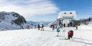 a group of people on a snow covered ski slope at lo Miete di Nonni in Champoluc