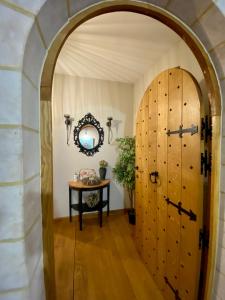 an archway leading to a room with a table and a door at The Charm in Bouillon