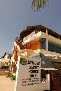 a building with a sign in front of it at Armaan Guest House in Diani Beach