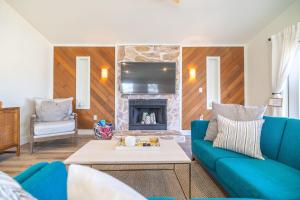 a living room with a blue couch and a fireplace at Bright New Beach House with In- Law Suite -- 2 blocks to beach! in St. Augustine