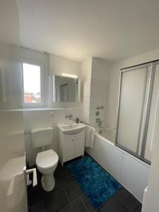 a white bathroom with a toilet and a sink at Sweet Home - 1 - in Moers