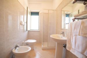 a bathroom with a toilet and a sink at Residence L'Africhetta in Rodi Garganico