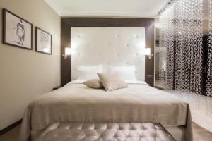 a bedroom with a large bed and a window at Hotel Constantine the Great in Belgrade