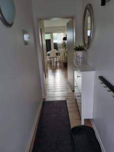 a hallway of a home with a mirror and a table at Wohnung Nr. 1 Willingen in Willingen