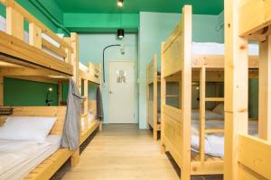 a room with wooden bunk beds in a hostel at On My Way Hualien Hostel in Hualien City