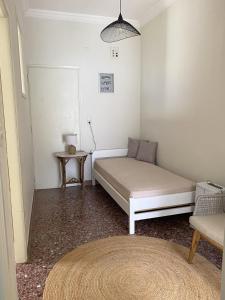 a small room with a bed and a table at Thassa Beach Apartment No4 in Leonidio +10 photos