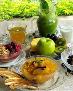 a table topped with bowls of food and a drink at Espaço Vaidya Ayurveda Pousada in Vale do Capao