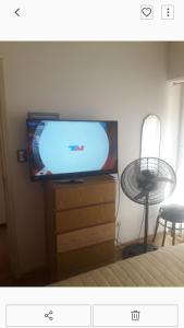 a flat screen tv sitting on top of a dresser at Panoramico Playa Grande -Solo Familias in Mar del Plata