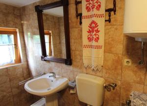a bathroom with a sink and a toilet and a mirror at Apartmani Purić in Malinska +25 photos