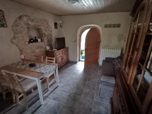 a living room with a table and a couch and a door at Apartmani Purić in Malinska