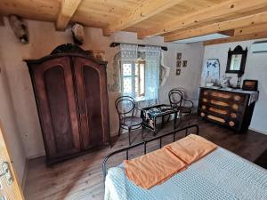 a bedroom with a bed and a cabinet and a table at Apartmani Purić in Malinska