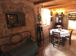 a dining room with a table and a table and chairs at Apartmani Purić in Malinska