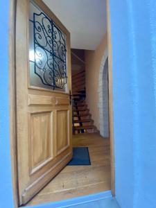 a door leading into a hallway with stairs at The Charm in Bouillon