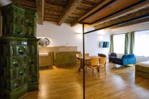 a living room with a large green cabinet and a table at Pension Krajinská 27 in České Budějovice