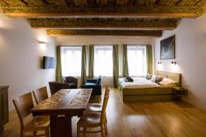 a bedroom with a bed and a table and chairs at Pension Krajinská 27 in České Budějovice