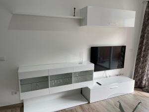 a white entertainment center with a flat screen tv at Neue Terrassenwohnung mit Pool Puerto de la Cruz in Puerto de la Cruz