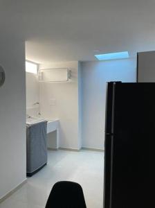 an empty room with a refrigerator and a kitchen at Apartamento pitalito in Pitalito