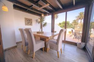 uma sala de jantar com uma mesa de madeira e cadeiras em Casita Palmera, Country Home, Haria, Lanzarote em Haría