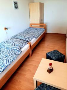 a small bedroom with a bed and a table at Holiday Erna - Apartments Cherry & Blue in Novigrad Istria +37 photos