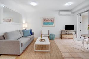 - un salon avec un canapé et une table dans l'établissement Iluka Twelve at Iluka Resort Apartments, à Palm Beach