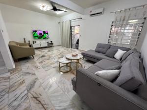 a living room with a couch and a table at M Guest House2 in Muar