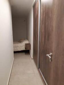 Habitación con puerta y dormitorio con cama en ELONCE en Balneario Claromecó