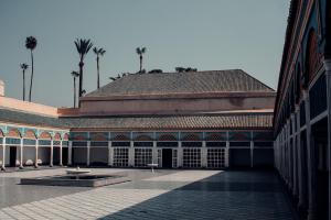 a building with a courtyard with palm trees in the background at Magnifique Duplex à Marrakech in Marrakech