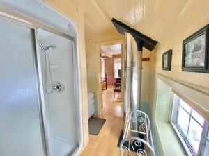 a walk in shower in a tiny house at 4 Bedroom Cottage on Manitoulin Island Next to Sand Beaches! in Providence Bay