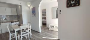 a kitchen and dining room with a table and chairs at Sunset Apartments in Slano